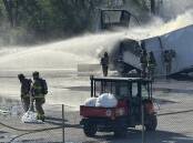 Firefighters tried to extinguish a blaze that began on a trailer carrying lithium batteries. (AP PHOTO)