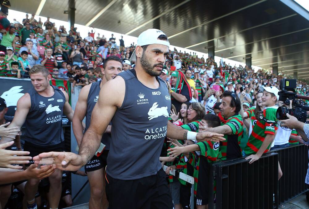 Greg Inglis is greeted by fans as he runs out for a training session earlier this week. 	Photo: GETTY IMAGES
