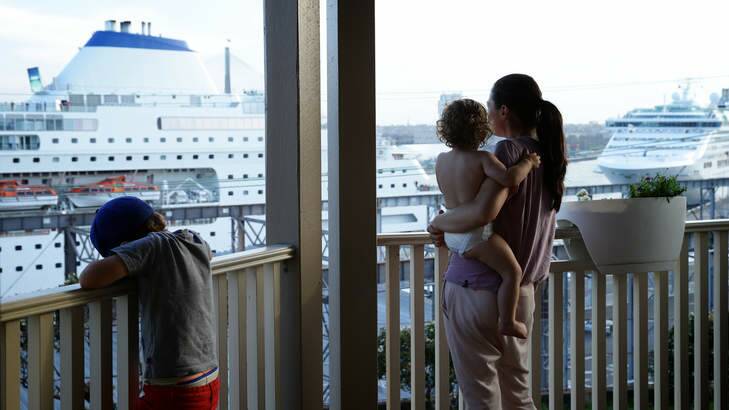 Worrying: Balmain resident Belinda Fitzgerald with 18 month old Lennox and Hewson, 5, watch the Pacific Pearl at White Bay Cruise Terminal. Photo: Wolter Peeters