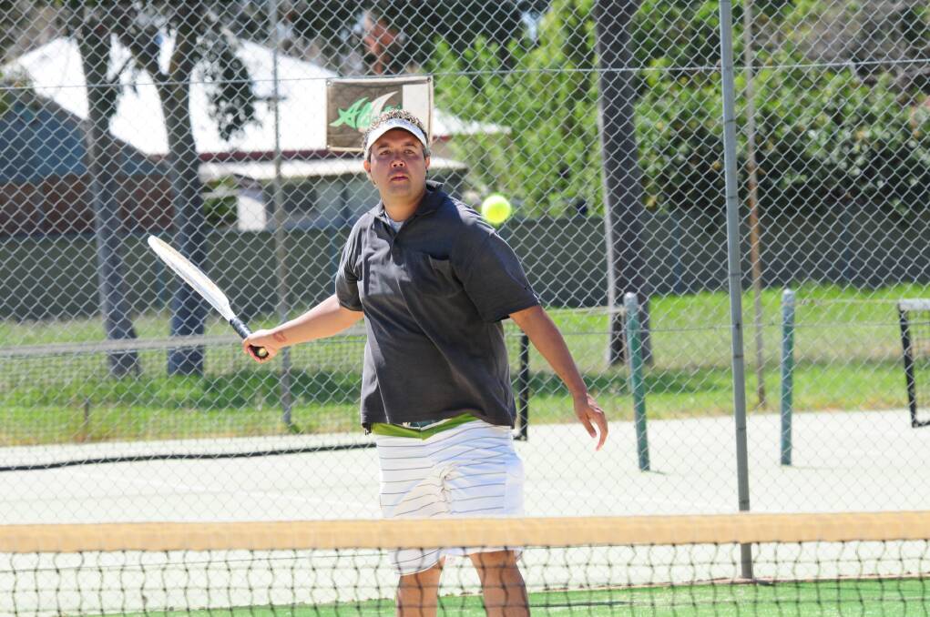 Mark Toomey keeps his eyes on the ball at the Muller Park Tennis Club s Grahame Priest and Warren McLennan Charity Day. 	Photos: GREG KEEN