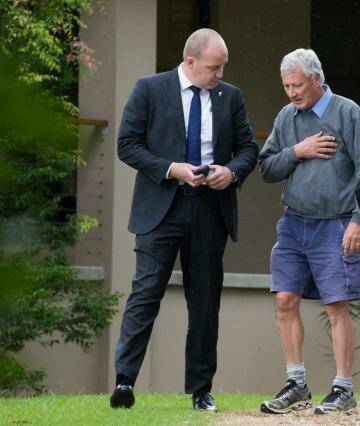 Bill Spedding, centre, is arrested in his Bonny Hills home by detectives on Wednesday.   Photo: Edwina Pickles