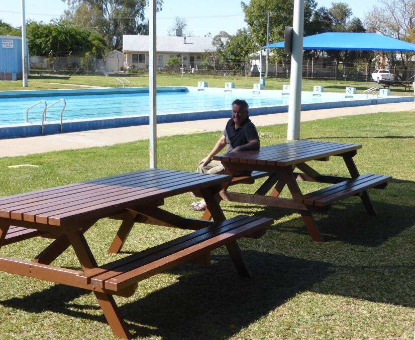 Kevin Brown poolside with the new picnic tables.