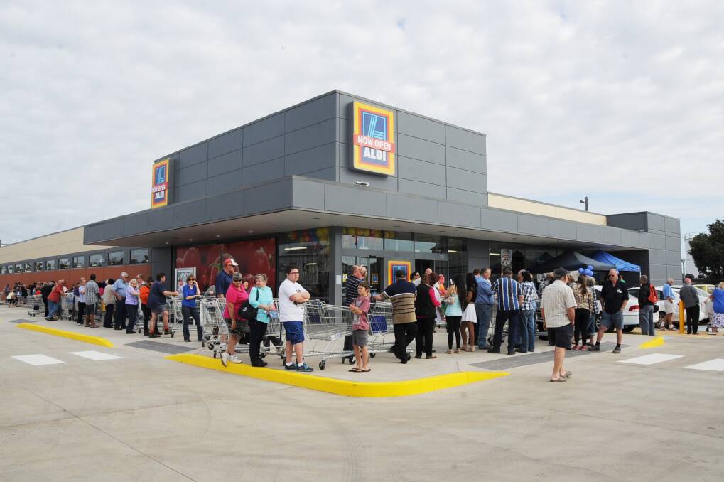 Shoppers queue outside ALDI before the store's opening at Dubbo. 	Photo: BELINDA SOOLE