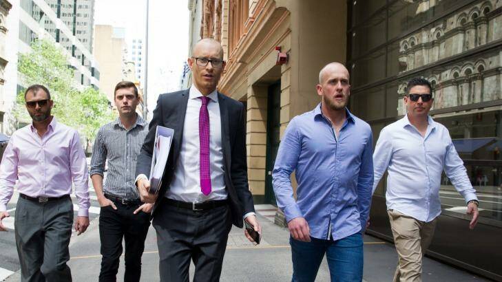 Shane Housego, Christian McDonald, Chris Sheehy and Steven Rapisarda join lawyer Nicholas Stewart (centre) to lodge papers at the NSW Civil and Administrative Tribunal in Sydney. Photo: Janie Barrett