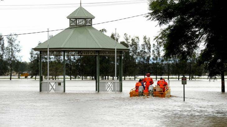 State Emergency Service crew set off in a flood boat to help residents in Raymond Terrace. Photo: Ryan Osland