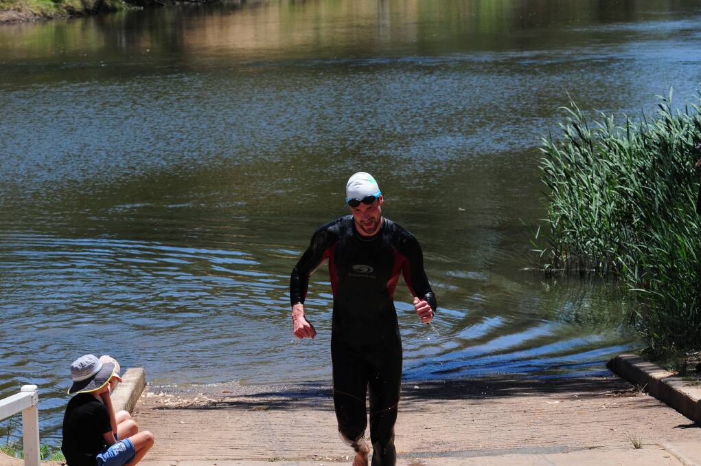 Murray Robertson leads the field out of the Macquarie River during the first leg of the EMS Tri For Charity. 		       Photo: GREG KEEN