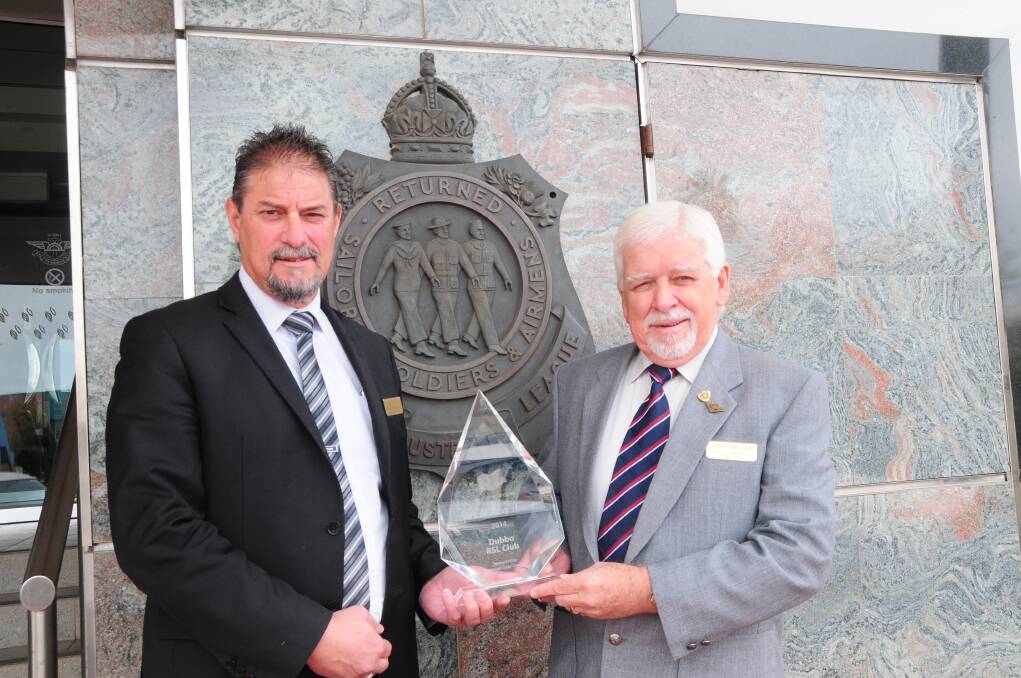 Dubbo RSL Memorial Club general manager Gus Lico and club president John Millar, with the 2014 Spirt of Anzac award.	 Photo: STEPHANIE KONATAR