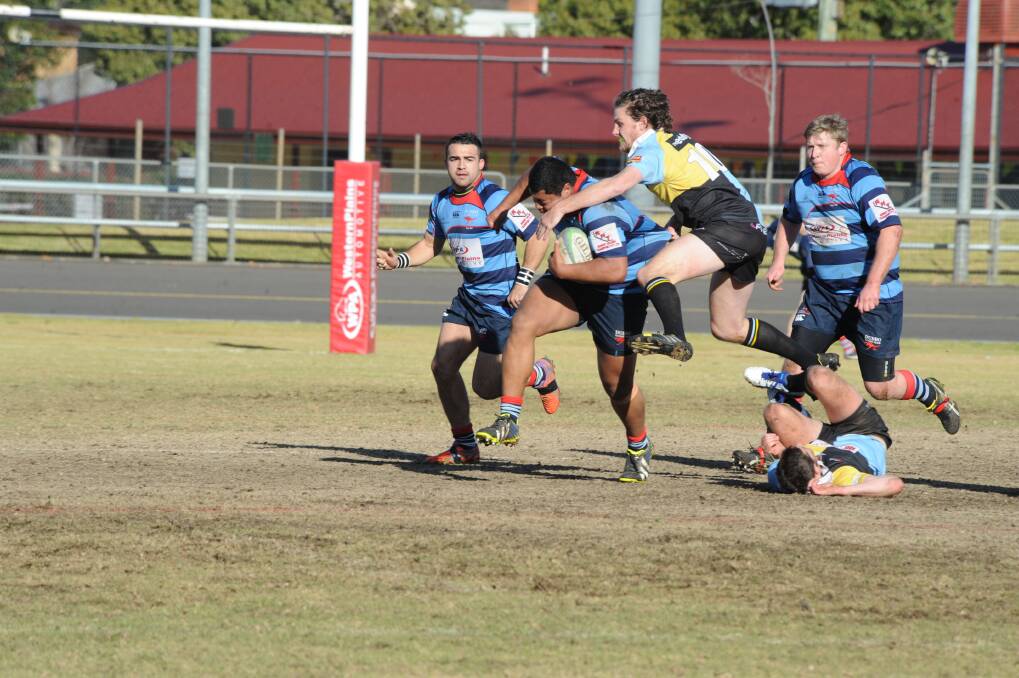 CSU defenders do their best to try and bring down big Roos prop Max Ma a Nelson during Saturday s clash at No.1 Oval.  
Photo: LOUISE DONGES