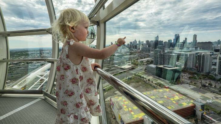 A child looks down from the Ferris wheel at Harbour Town. Photo: Luis Ascui