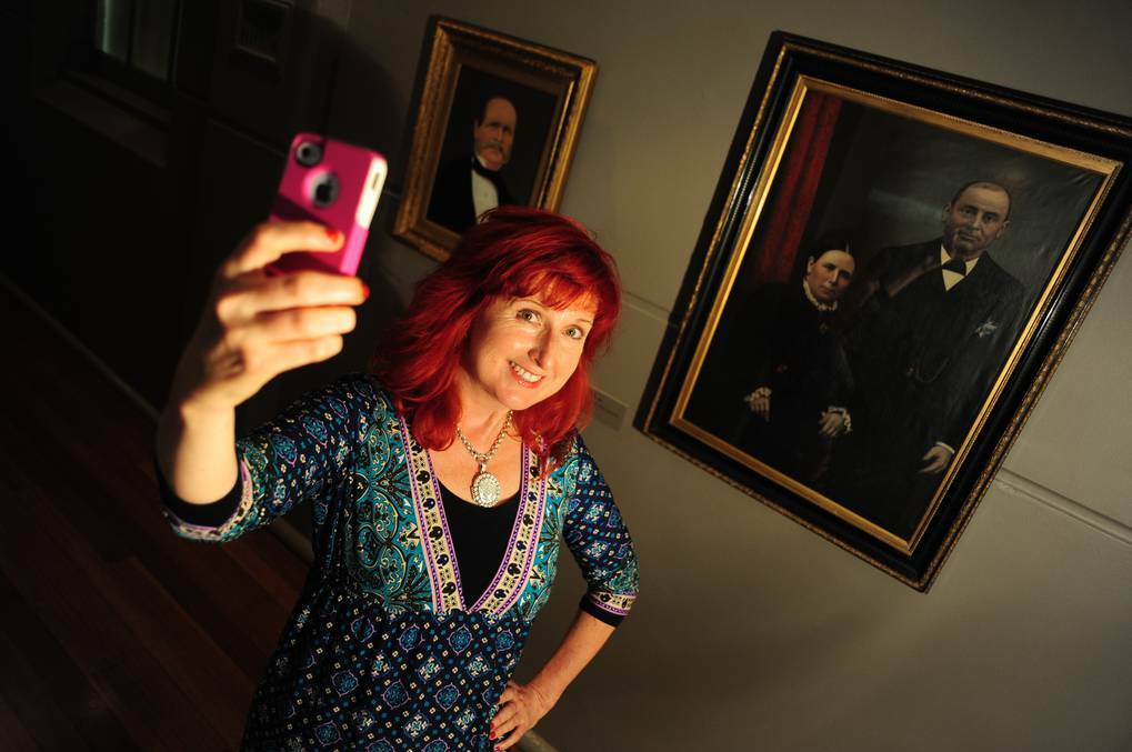 DUBBO: WPCC education officer Lisa Minner, taking a selfie alongside the gallery's traditional portraits. Photo: BELINDA SOOLE