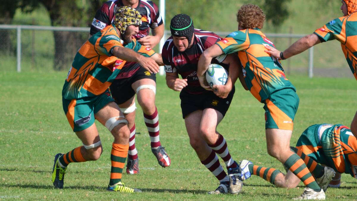 PARKES BOARS: Orange City's Jake Davis and Duncan Young try to bring down Parkes Richard Webb. 