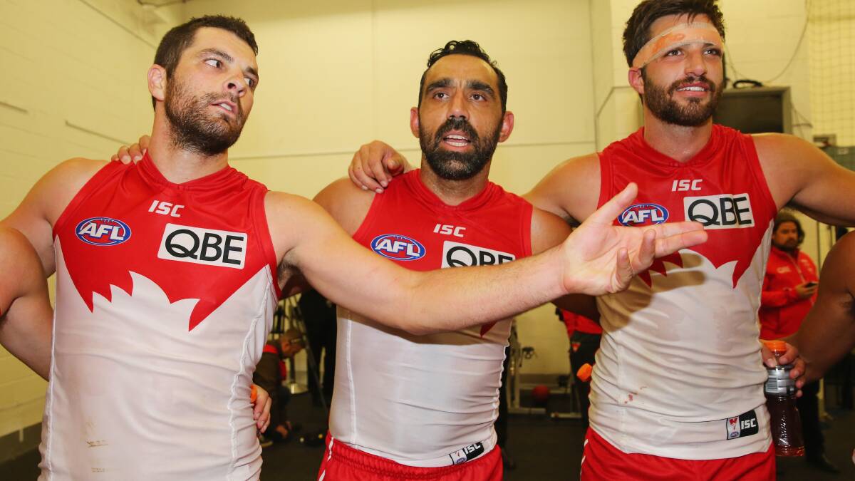 Adam Goodes of the Swans sings the team song in the changing rooms. Picture: Getty Images.