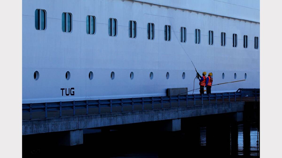 Cleaners working dockside on the Celebrity Solstice. Picture: Simone De Peak