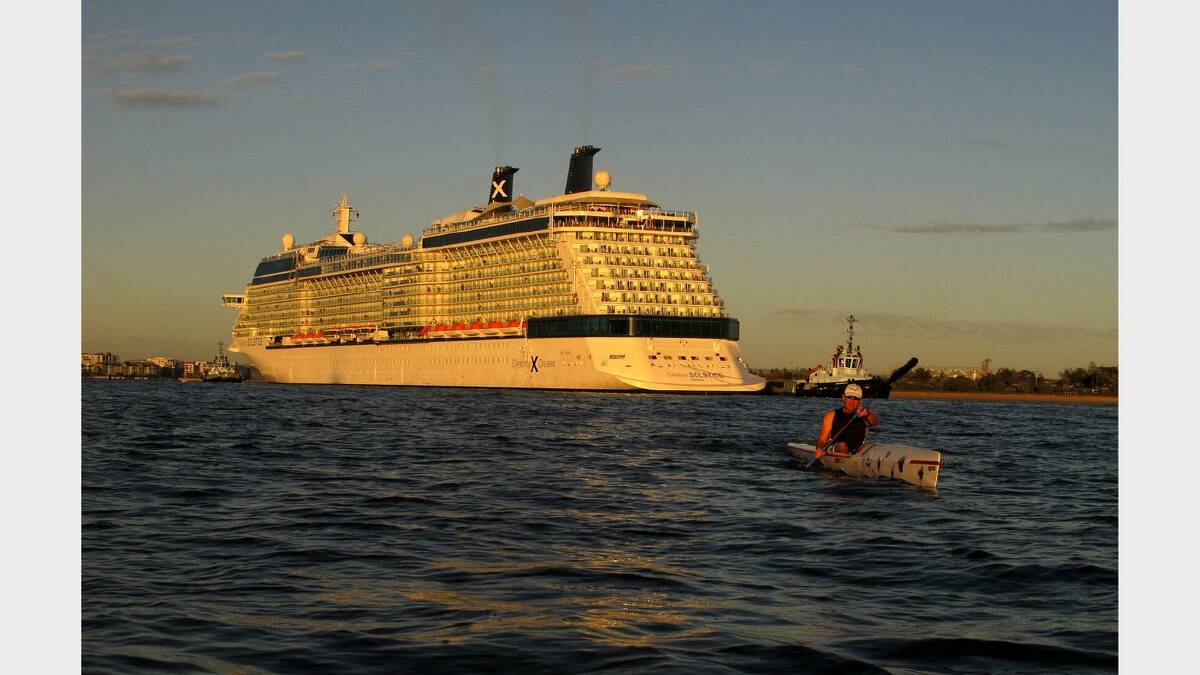  Cruise ship Celebrity Solstice enters the Port of Newcastle. Glen Coulam paddles past. Picture Darren Pateman