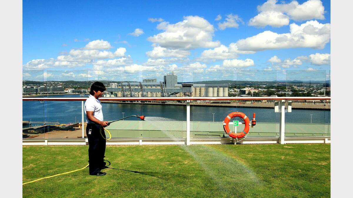 On board the Celebrity Solstice. The Lawn Club area with actual grass gets a watering. Picture: Simone De Peak 