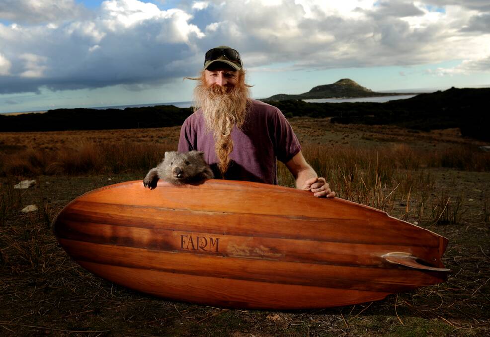 Surfboard maker Addy Jones and his pet wombat Womy. Pictures: GEOFF ROBSON