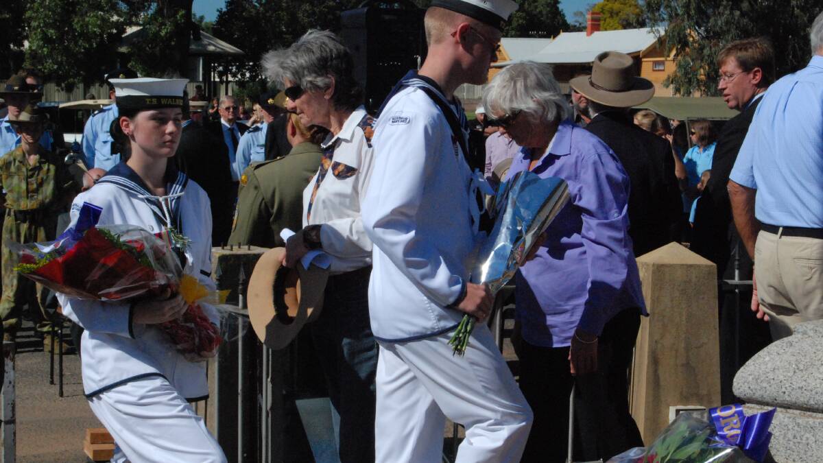 MORNING SERVICE: Janee Roberts and William Marshall from the Navy lay personal wreaths 