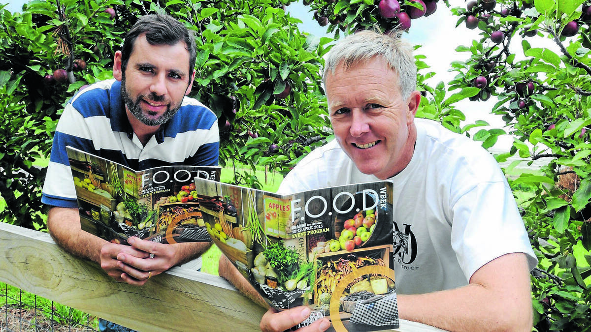 TASTY: Michael Sobotta and Orange FOOD Week president James Sweetapple with the program for this year’s festival. Photo: JUDE KEOGH 0126food1