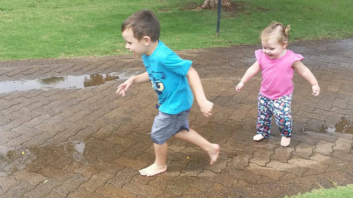 Kyrese Ruttley (4) and Kaydi Ruttley (18 months) enjoying the puddles in Dubbo yesterday thanks to the weekend rain in Dubbo.PHOTO: CONTRIBUTED