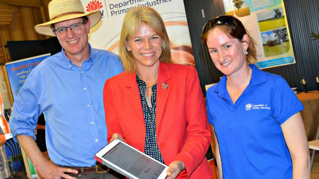 Orange MP Andrew Gee, Minister for Primary Industries Katrina Hodgkinson and DPI beef development officer Patricia O'Keefe launching the new Drought Feed Calculator app at the Australian National Field Days.