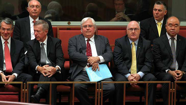 Palmer United Party leader Clive Palmer, centre, observes PUP Senators being sworn into the Senate. Photo: Alex Ellinghausen