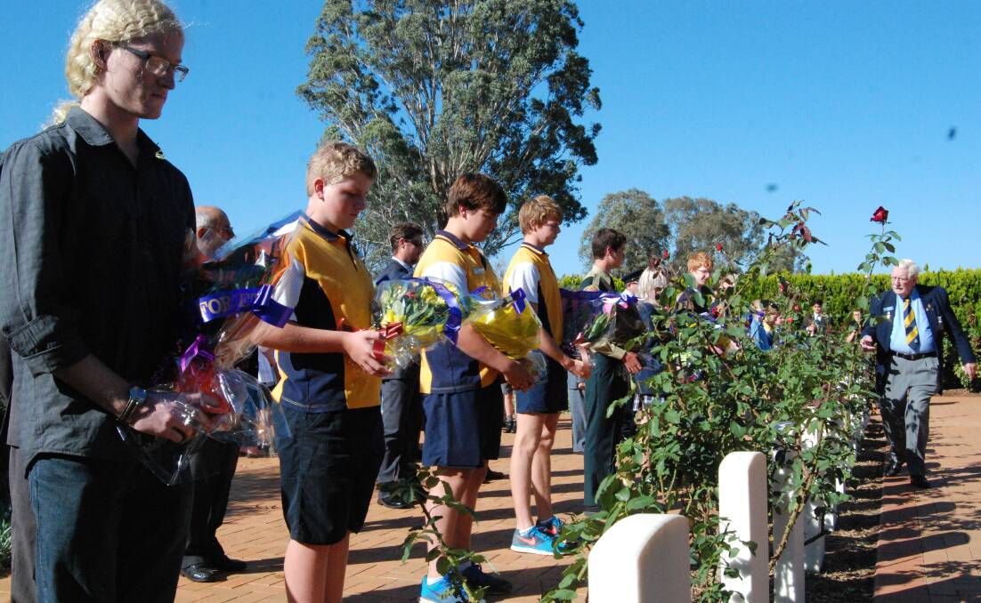 THE WAR CEMETERY SERVICE: Students getting ready to put down their wreaths 