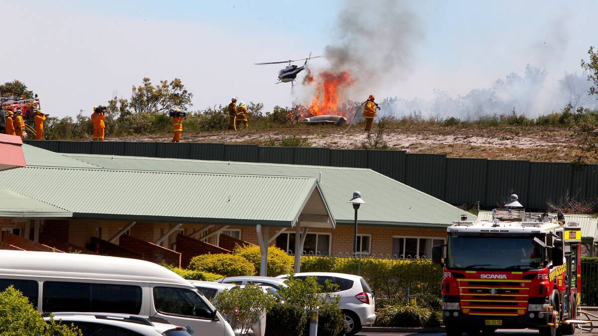 Firefighters protect the Redhead Gardens Nursing Home near Redhead Road. Photo by Phil Hearne.