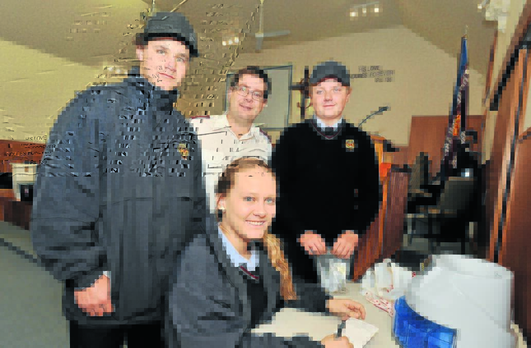 TOP HONOURS: James Sheahan Catholic High School volunteers Kosta Christodoulos, Jake Mackin and Gabbi Meacham with Salvation Army Captain David Grounds during the weekend’s Red Shield Appeal. Photo: JUDE KEOGH 0529jksalvos2