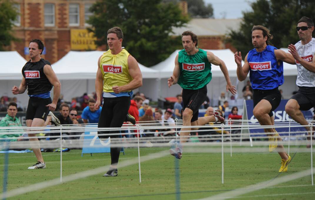 Murray Goodwin, yellow, wins heat 9 of the 2014 Stawell Gift. 