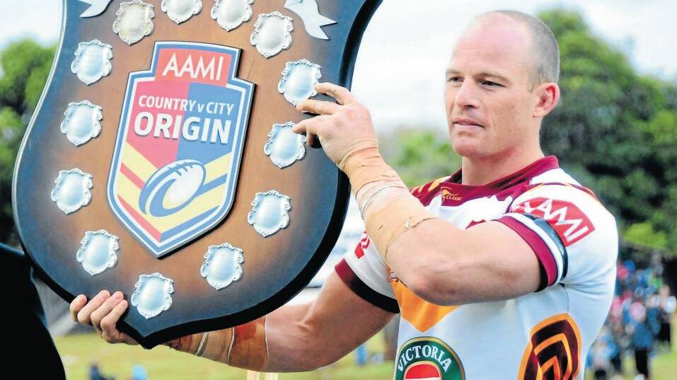 Country captain Beau Scott with the Country-City Shield after the fixture at Dubbo this year. The match is a chance of retuning to Caltex Park in 2015. 
Photo: LOUISE DONGES