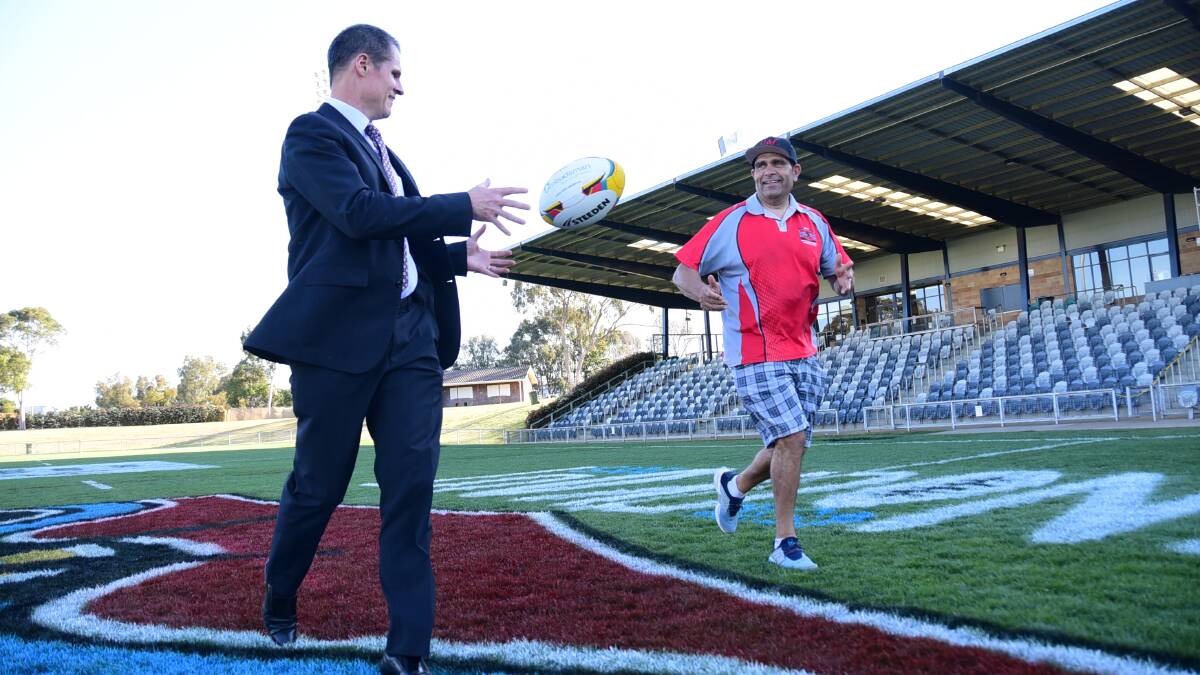 Dubbo mayor Mathew Dickerson with Geoff Simpson from the Walgett Aborigitnal Connection team passing the ball around for what will be a lucrative weekend in the city. Photo: BELINDA SOOLE