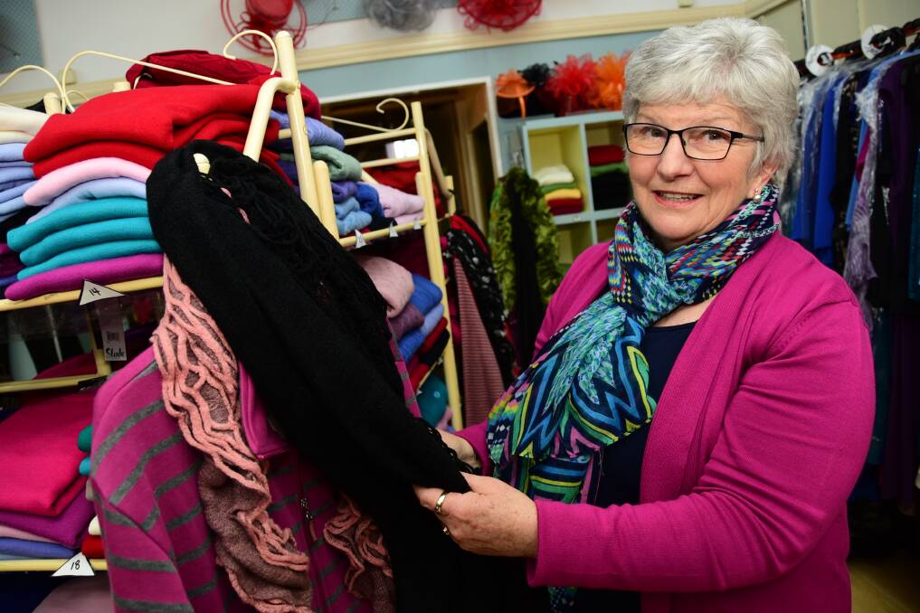Sue Shields demonstrating some of the scarves at Talbragar Street Store Big on Style. Photo: BELINDA SOOLE