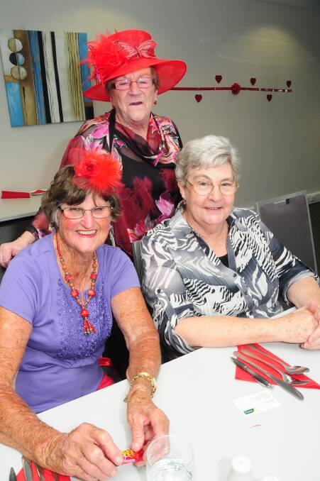 RED HAT LADIES: Marie Roberts, Pam Ridley and Helen Schiemer. Photo: JOSH HEARD.