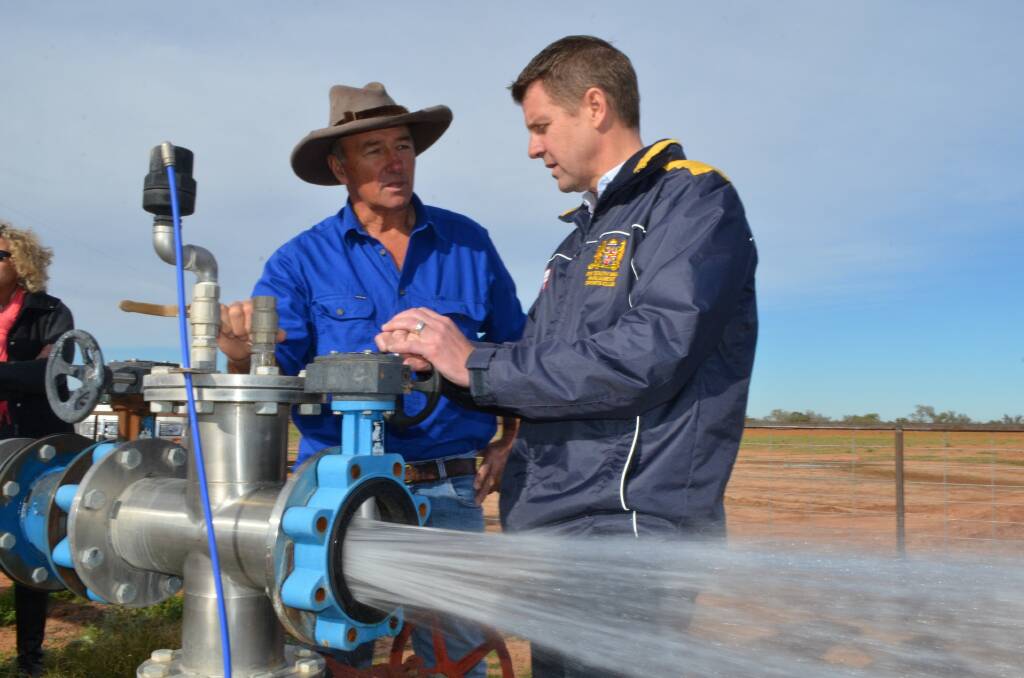 Premier Mike Baird talks about bore pipe and cap works with Weilmoringle farmer Ed Fessey in August last year. Photo: CONTRIBUTED