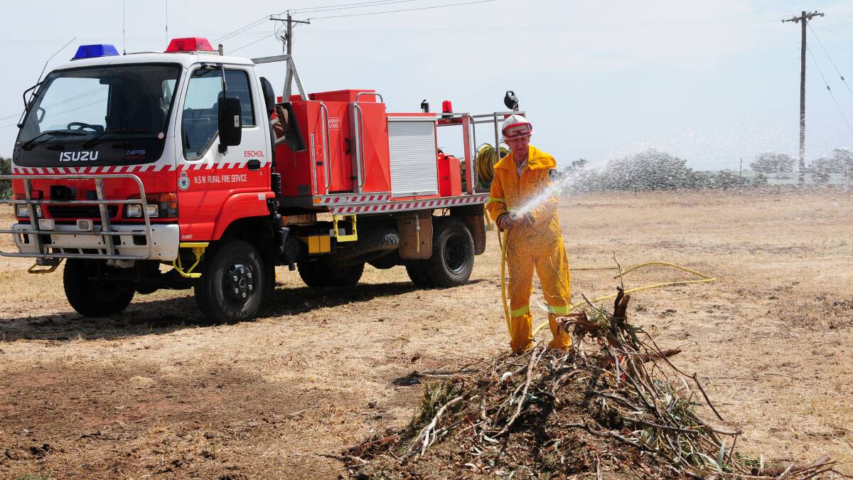 Bruce Dowling of the Eschol Brigade putting out a fire on an Old Dubbo Road property. Photo: GREG KEEN