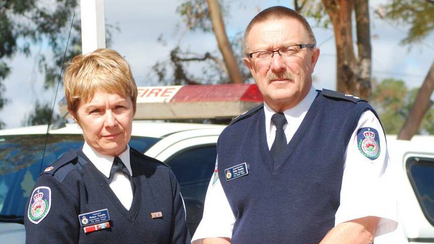 Cobar's Robyn and Chris Favelle were among Rural Fire Service personnel who paid tribute to firefighter Daniel Howard, who died battling a blaze in the town on Sunday. Photo: GRACE RYAN.