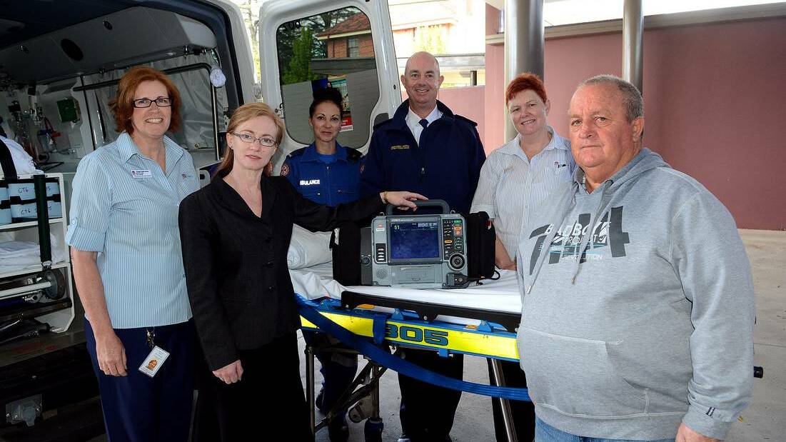 SAVING LIVES: Estelle Ryan CNC Cardiology, Cardiologist Dr Ruth Arnold, paramedics Claire Green and Adam Parker, Anne Morrison NUM ICU and Coronary Care and bypass patient Terry Babbage with the lifesaving ECG machine. Photo: PHILL MURRAY