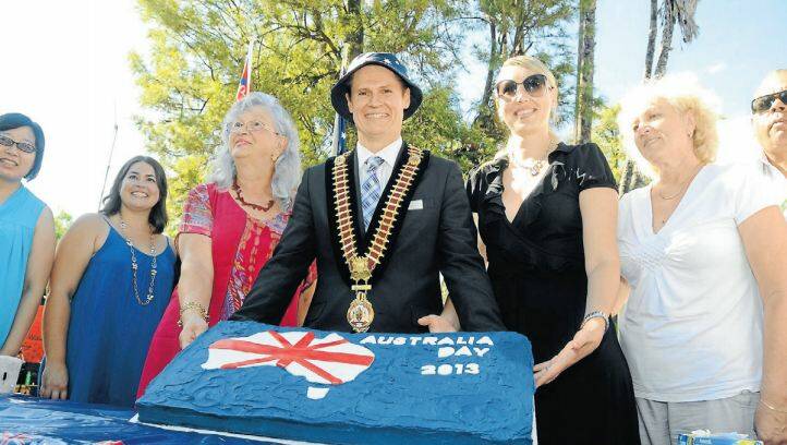 AUSTRALIA DAY HONOURS 2013: Dubbo mayor Mathew Dickerson with some of our newest citizens and an Australia Day cake. Photo: KATHRYN O’SULLIVAN