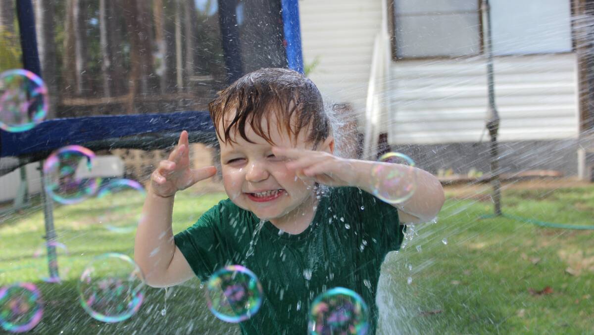 Enjoying a spray with the hose and some bubbles! Photo submitted by Kellee. 