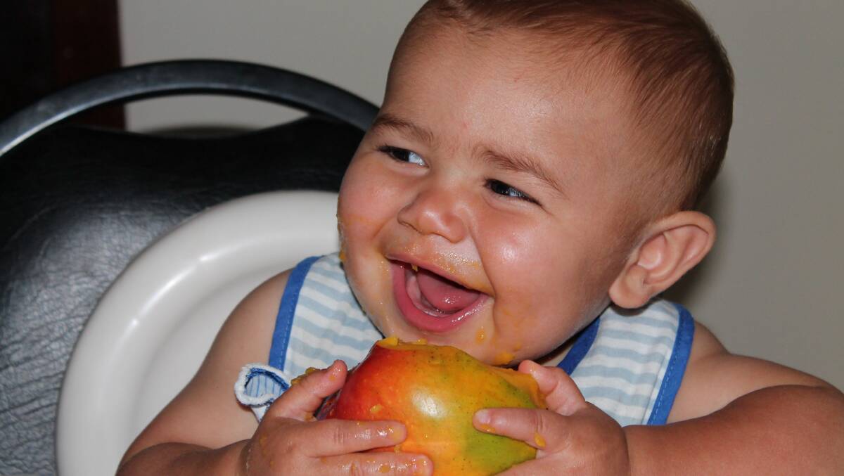 Elias eating his first Mango. Photo submitted by Marian Irwin
