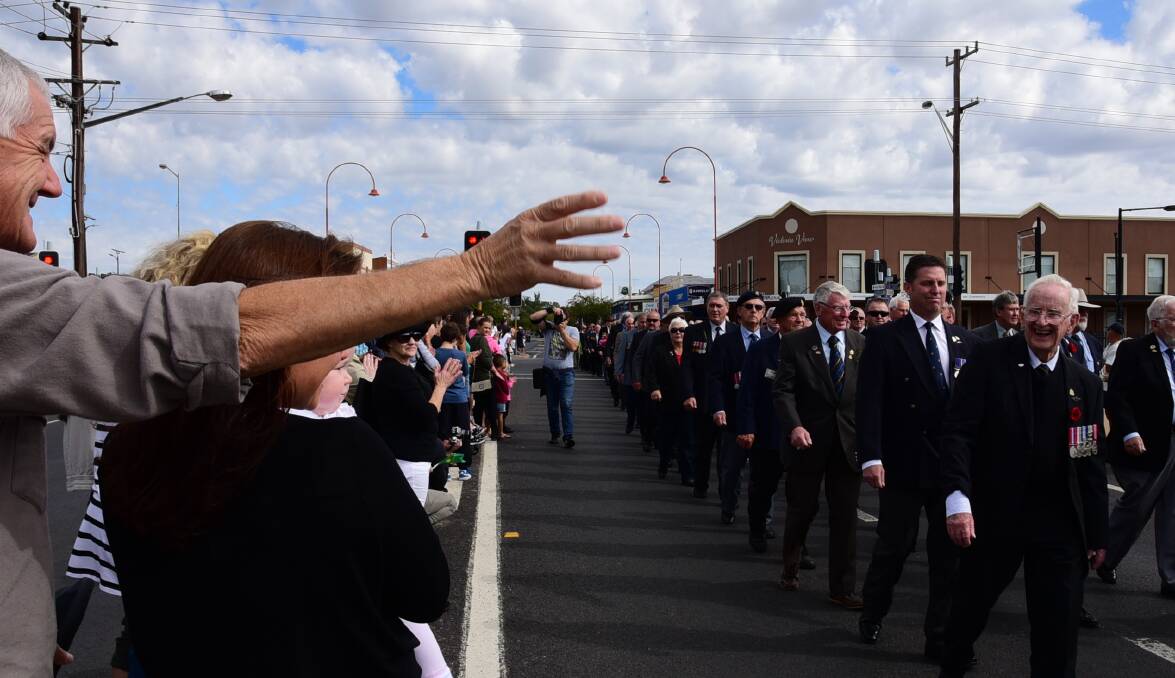 Dubbo poet Ron Stevens (marching, right) marches during the Anzac Day march in Dubbo. Photo: BELINDA SOOLE