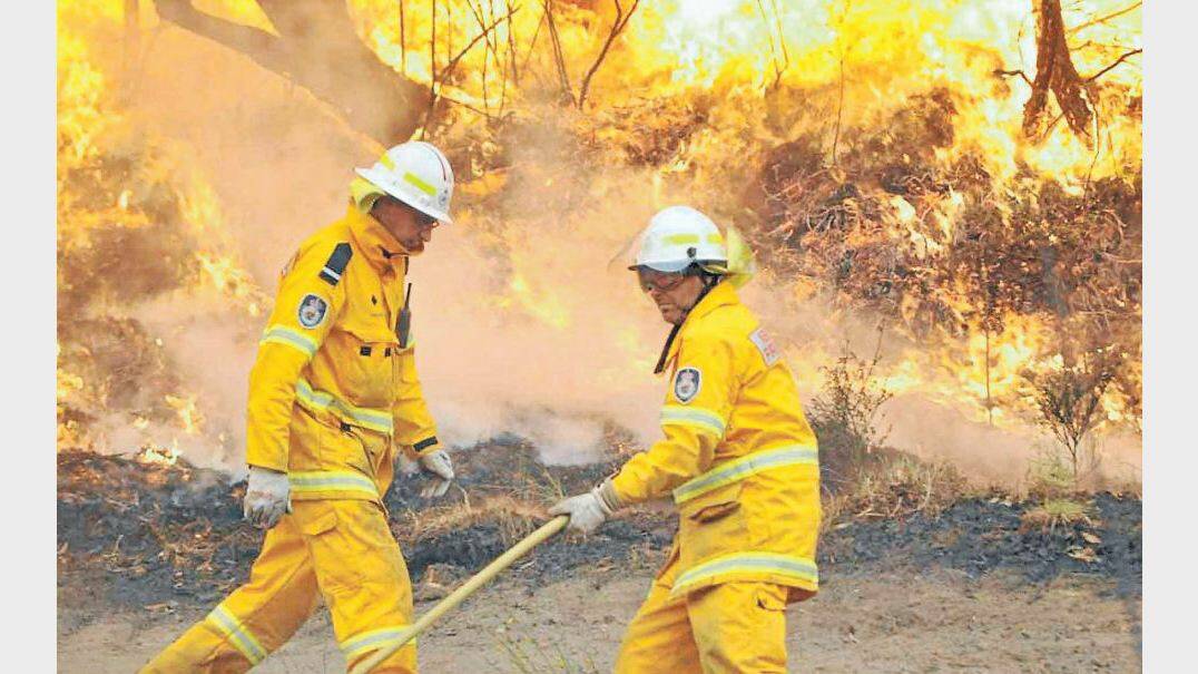 OCTOBER: Rural Fire Service volunteers, among them teams from the orana area, in action near Lithgow. Photo: CAROLYN PIGGOTT