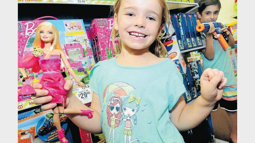DECEMBER:  Playing with some of the top five toys for Target in the Orana region is Mia with a Fashionista Barbie doll and Lachlan Rummans with a Nerf Retaliator. Photo: LOUISE DONGES