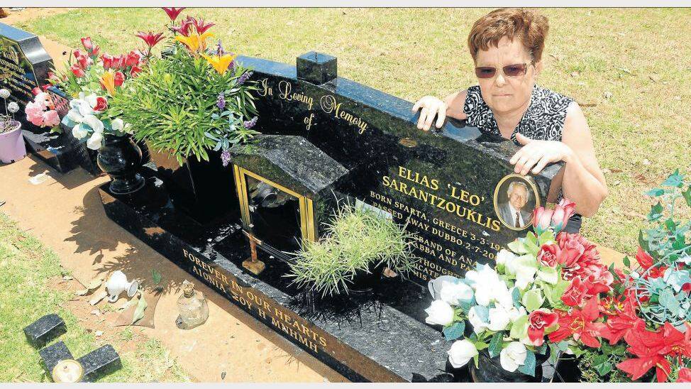 DECEMBER: Anna Sarantzouklis holds back tears as she looks in horror at her husband’s desecrated grave. Photo: KATHRYN O'SULLIVAN
