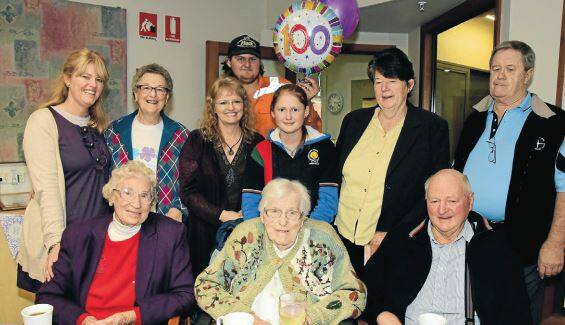 Edith Sweeney, front centre, celebrating with a drop of chardonnay on her 100th birthday with family members.Back: Maria Logan, Eunice Sweeney, Cheryl Martin, Corey Martin, April Martin, Elaine Hartley, Cliff Westbury, Phylis Hartley and Reg Sweeney. Photo: BELINDA SOOLE