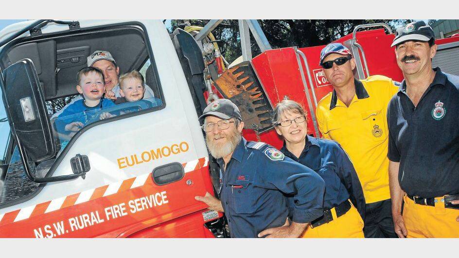 SEPTEMBER: Charlie, Dave and Andy Cullenward explore how firefighters Barry Whalan, Lyn Whalan, Gordon Cowen and Trevor Munro work during the Rural Fire Service open day. Photo: JOSH HEARD