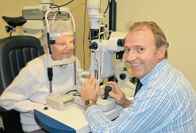 Burgun and Brennan optometrist Tony Burgun conducting an eye examination on Joan Cox. Photo: TAYLOR JURD