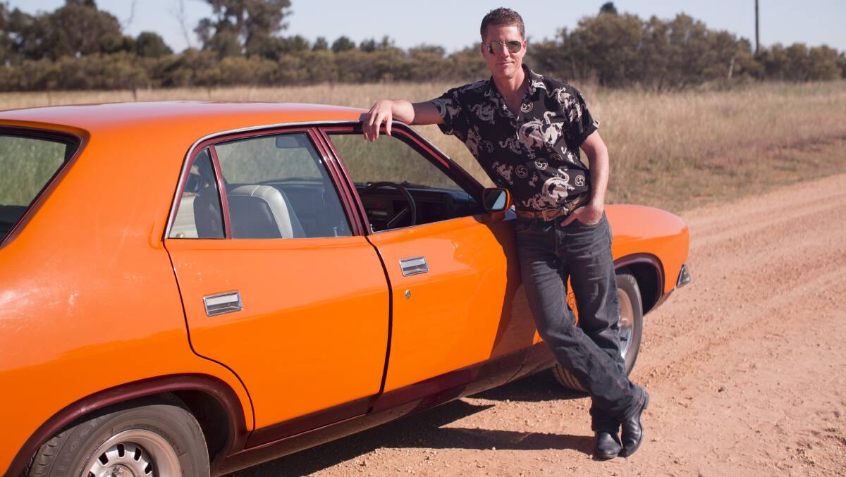 Film and TV historian Andrew Mercado with a Ford GT during a shoot that took place at Dubbo this week ahead of an upcoming special on cult Australian films of the 1970s and 1980s. Photo: SBS