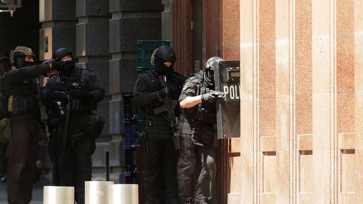Armed policeman are seen outside Lindt Cafe on Philip St, Martin Place on December 15, 2014 in Sydney. Police attend a hostage situation at Lindt Cafe in Martin Place. Photo by Mark Metcalfe/Getty Images