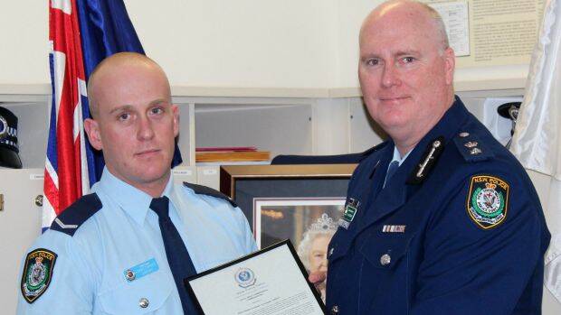 Christopher Sheehy (left) receives a bravery award from Newtown Police Commander Simon Hardman in September 2015. The young officer was being covertly monitored during the same period on the recommendation of his boss.  Photo: Supplied
